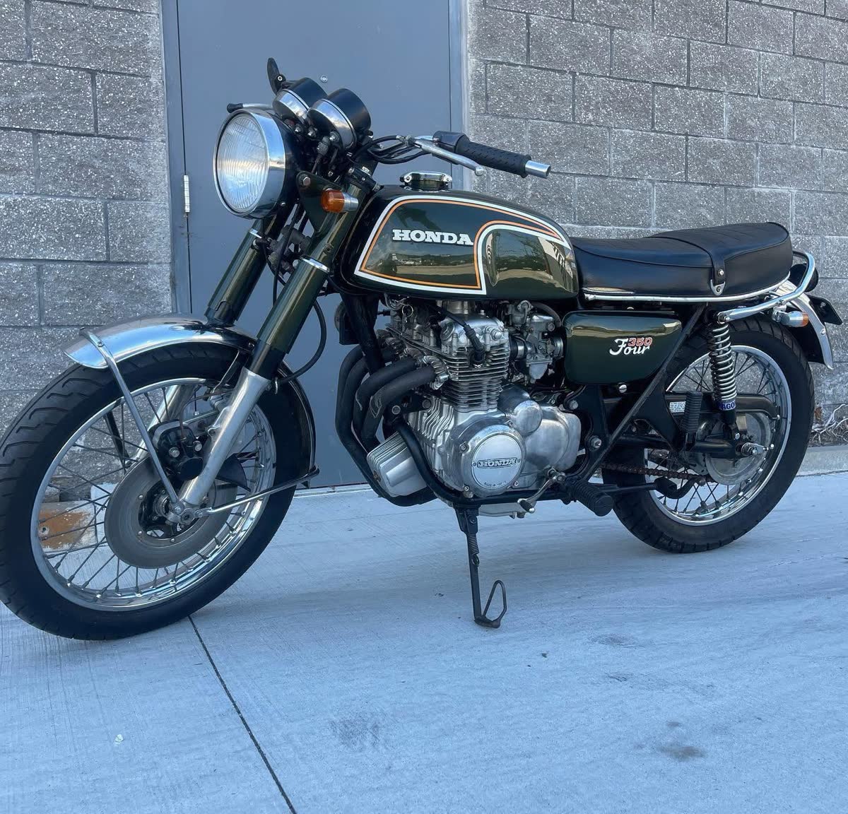 Vintage Honda motorcycle parked outside the shop
