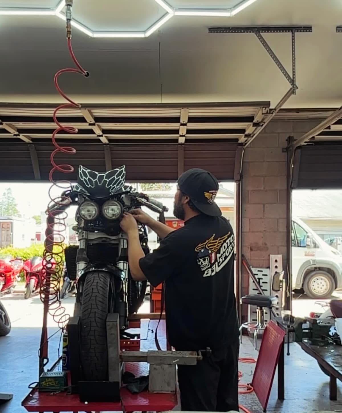 Technician working on a bike under the shop lights
