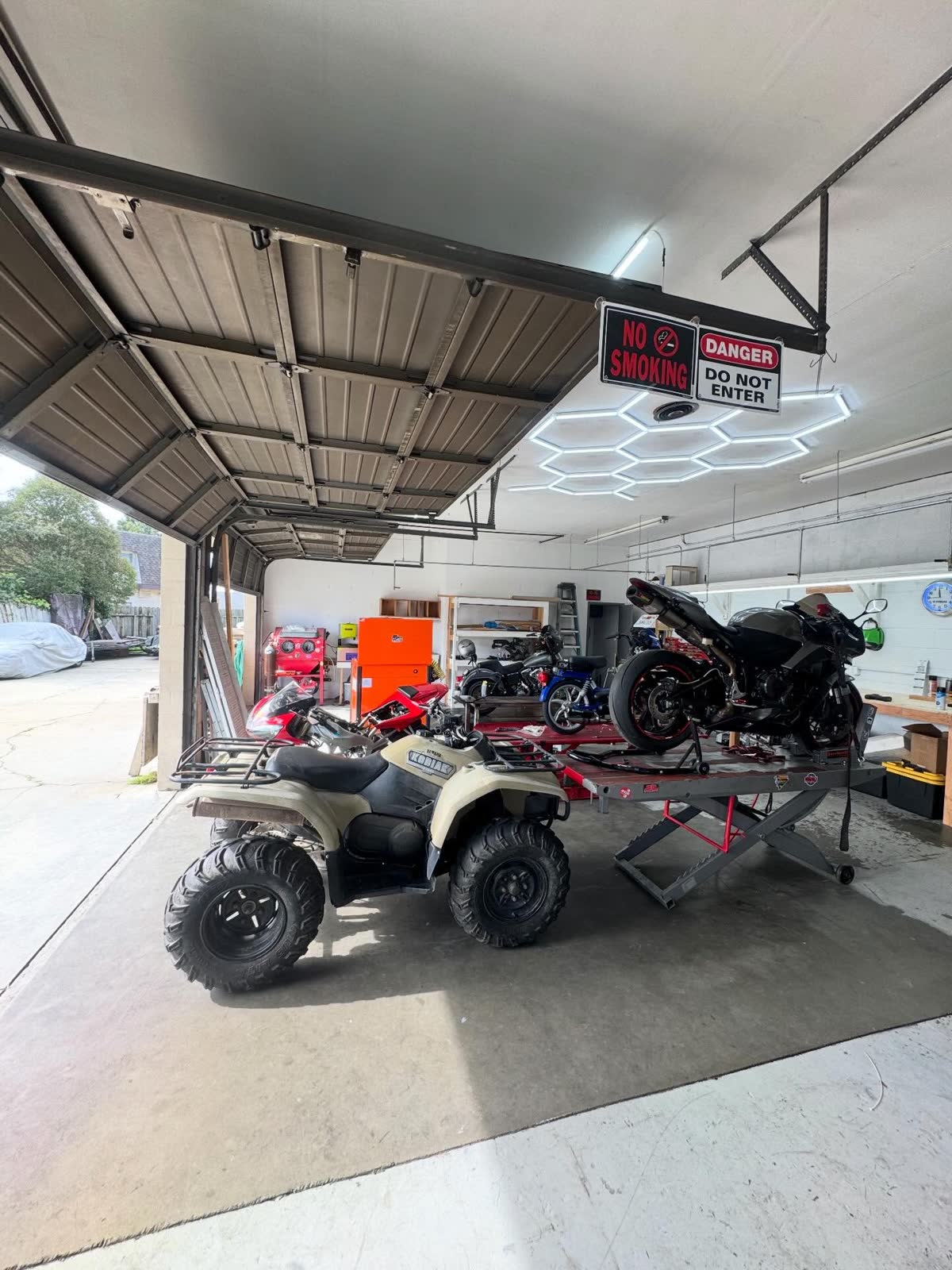 ATV and sportbike in the shop bay