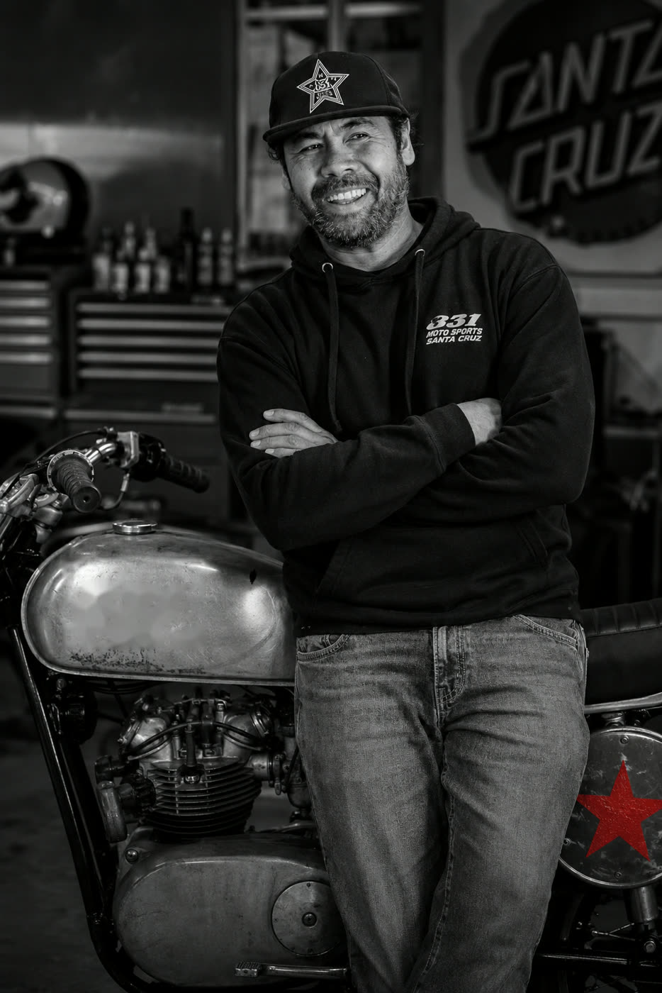 Jim Rama in the 831 Moto Sports garage, leaning on a vintage motorcycle